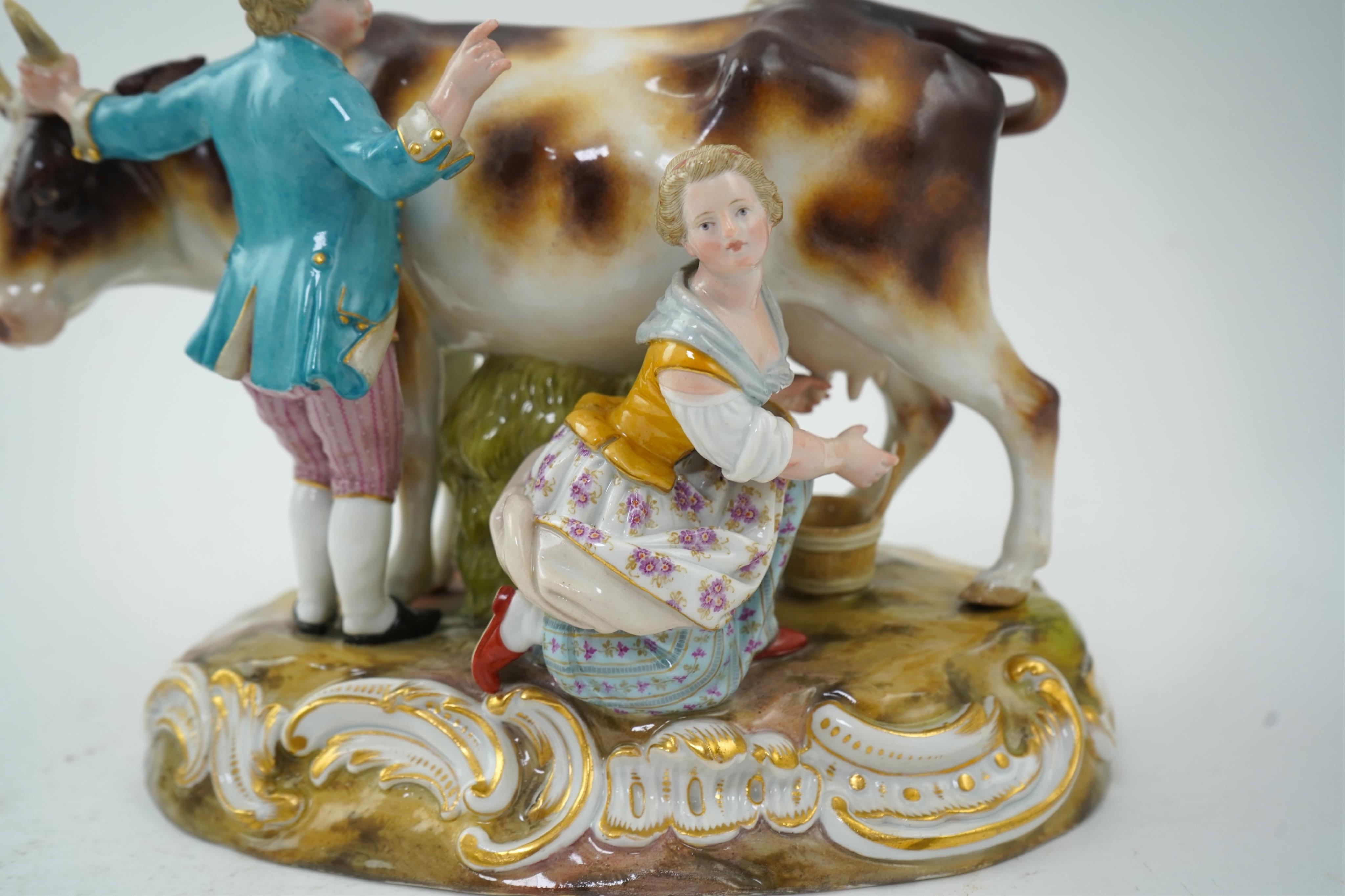 A Meissen group of a boy and girl milking a cow, 19th century